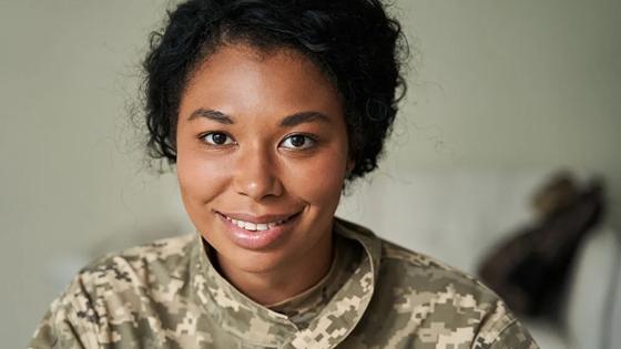 Woman in military fatigues facing the camera