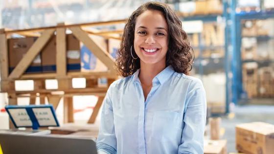 Photo of woman working in a warehouse environment in supply chain management