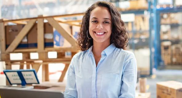 Photo of woman working in a warehouse environment in supply chain management