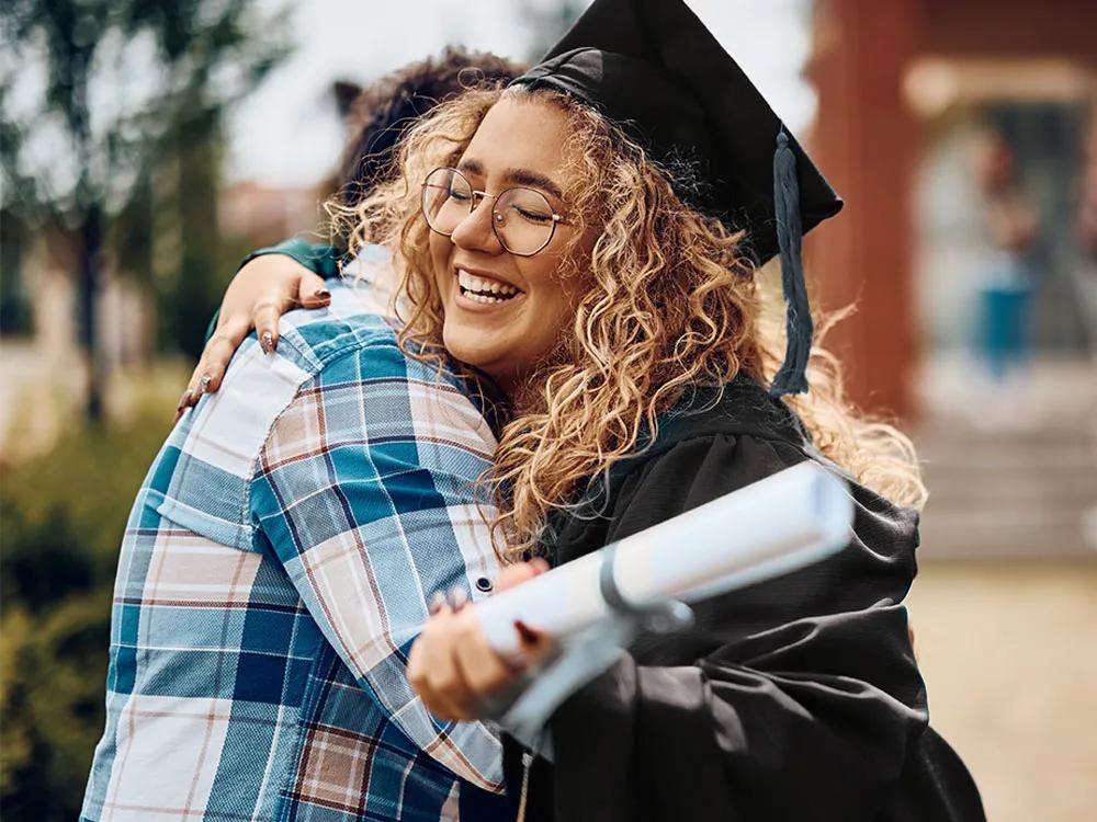 Graduate student wearing a cap and gown during commencement.