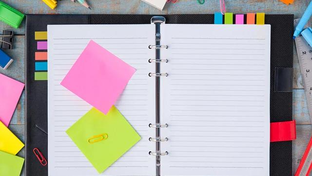 Overhead view of an open notebook with sticky notes