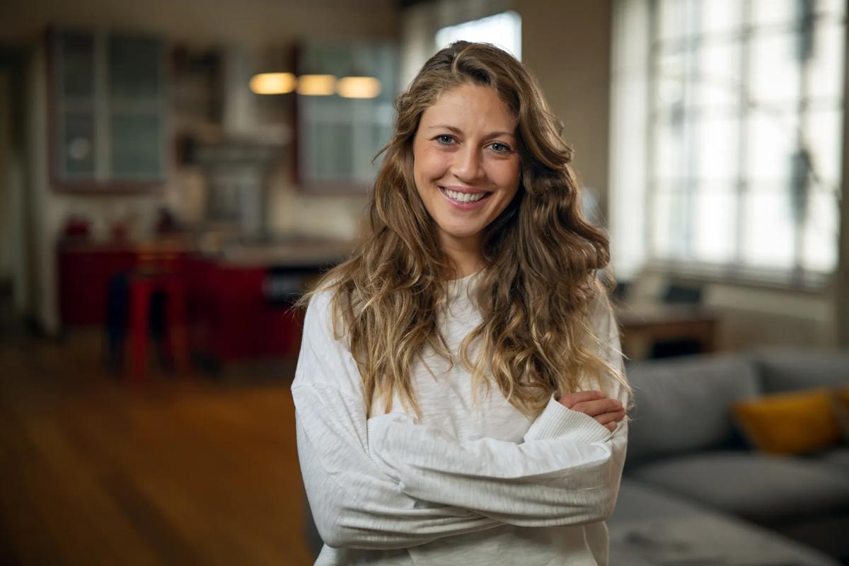 Woman smiling inside a university building.